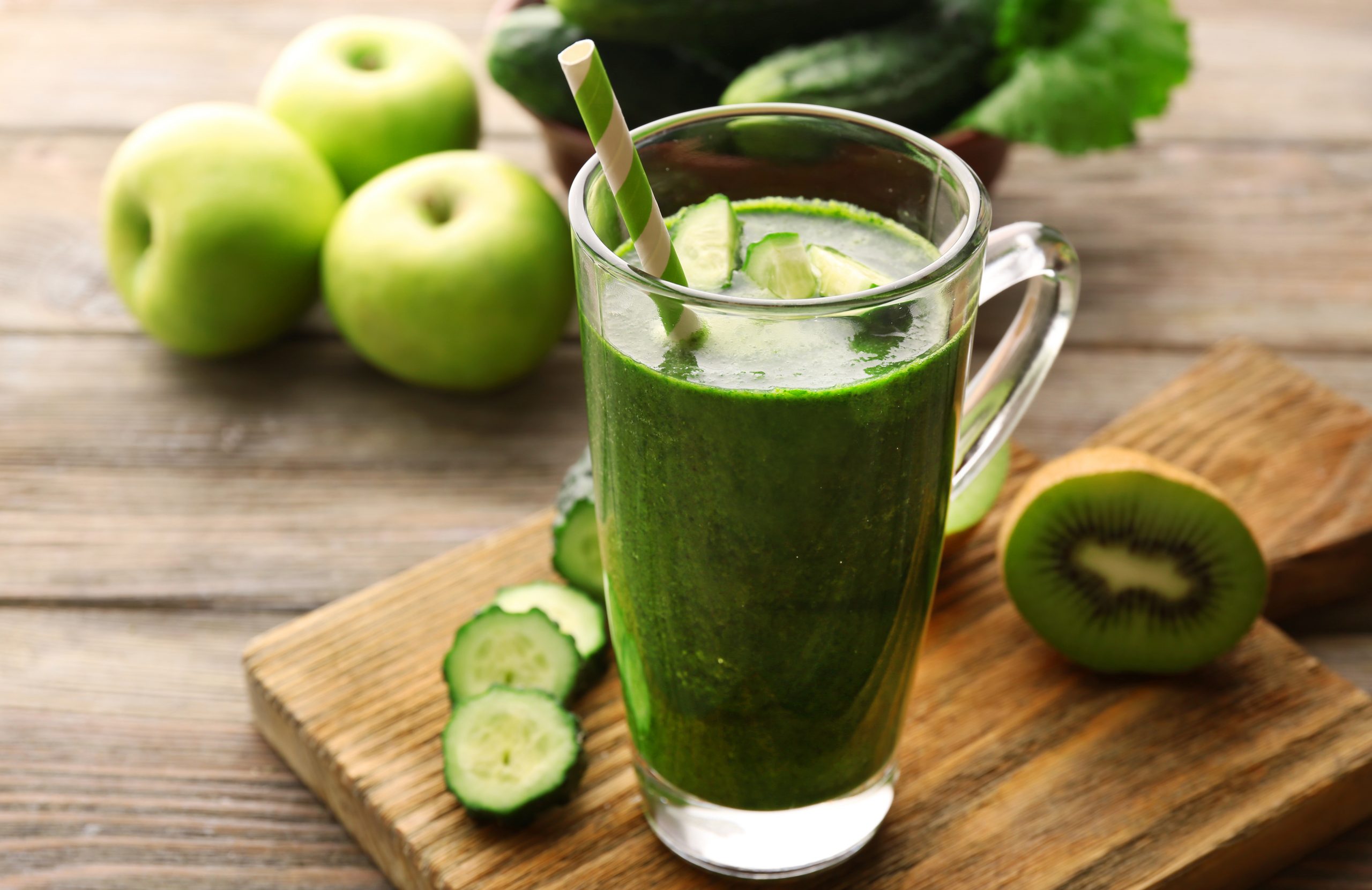 Green fresh healthy juice with fruits and vegetables on cutting ...